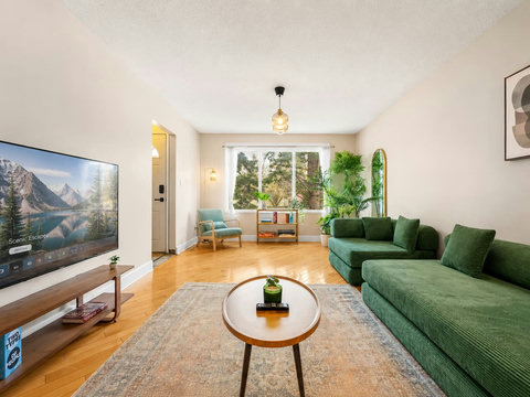 Comfortable living room flooded with natural light and modern amenities