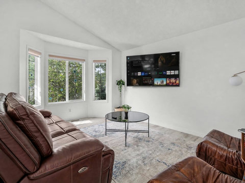 Comfortable living room with premium leather seating and entertainment system