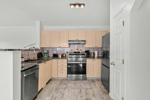 Fully equipped kitchen with modern stainless steel appliances and ample counter space