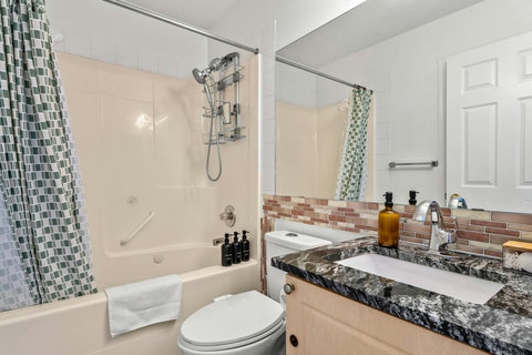 Spa-inspired bathroom featuring dual sinks and walk-in shower