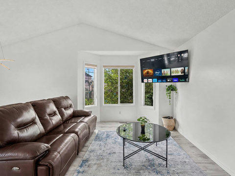 Comfortable living room with premium leather seating and streaming entertainment