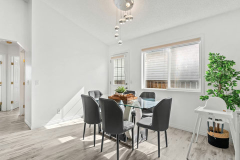 Bright dining space with floor-to-ceiling windows and modern seating