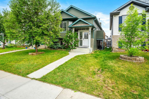 Welcoming front entrance with lush landscaping and mature shade trees