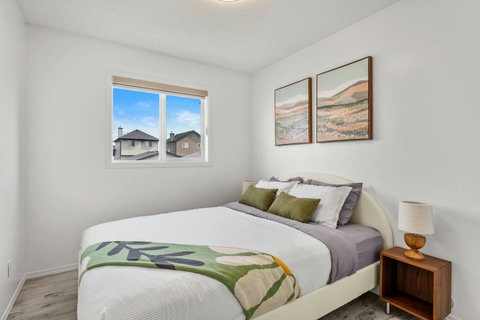 Comfortable guest bedroom with natural light and modern furnishings