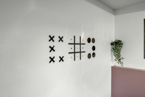 Playful living space with creative wall games and fresh greenery accents