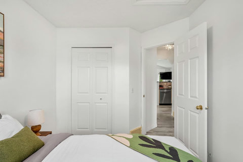 Comfortable guest bedroom with soft natural light and modern décor throughout
