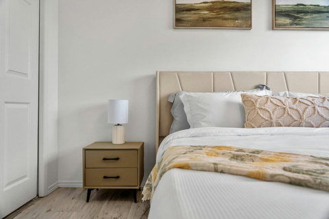 Serene guest bedroom with soft neutral tones and contemporary furnishings