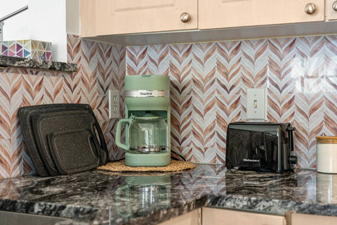 Well-equipped kitchen countertop featuring Starfrit coffee maker and modern appliances