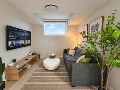 Living room with large smart TV and queen sofa bed