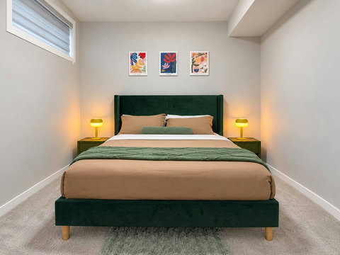 Bedroom 1: queen bed with nightstands and lamps
