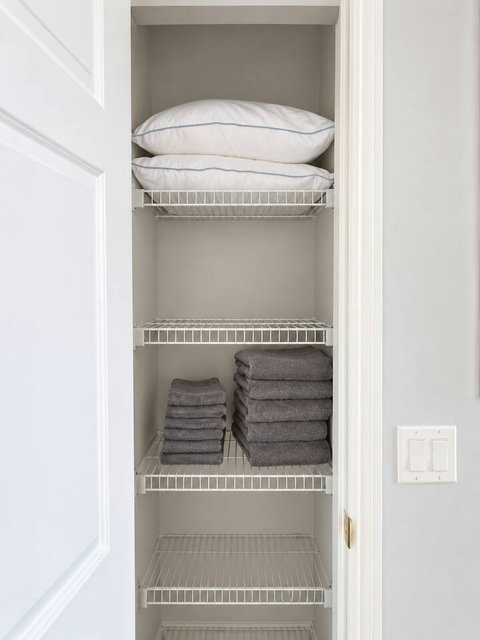 Linen storage with extra pillows and towels.