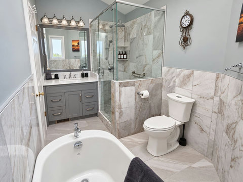 Private ensuite bathroom adjoining the primary bedroom, with a bathtub and separate glass shower.