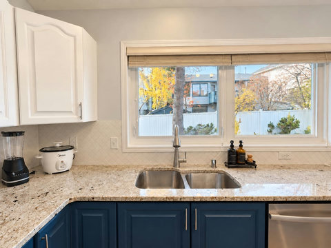 Kitchen sink and dishwasher beneath the window.