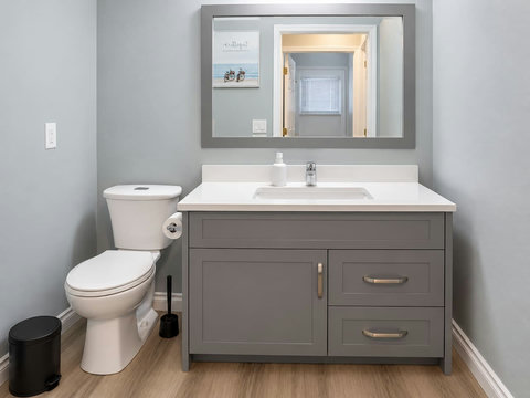 Main-floor powder room near the garage entrance and laundry area, with a toilet and vanity.
