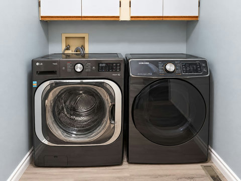 Main-floor laundry area with washer and dryer near the garage entrance.