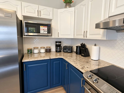 Kitchen counter with microwave, coffee maker and meal-preparation space.