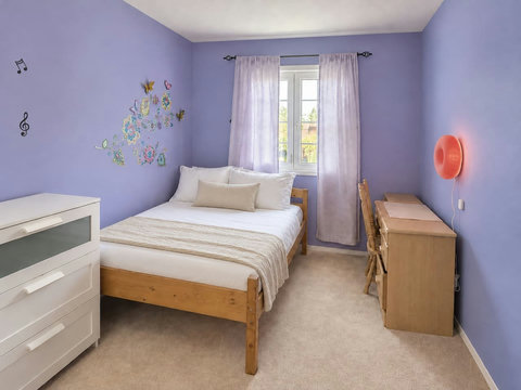 Upstairs bedroom with one double bed, desk and wardrobe.