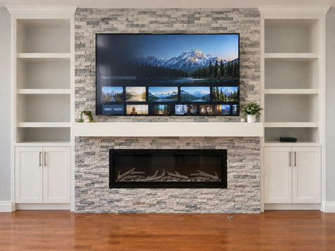 TV and fireplace with matching built-in shelving in the main-floor family living room.