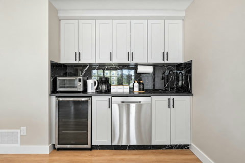 Sunlit game room with stocked kitchenette-4