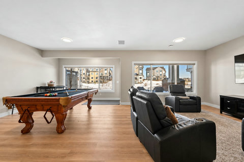 Dining nook tucked beside pool table-5