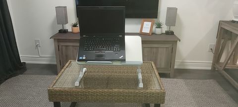 You can work on a comfortable couch with portable laptop stand on the coffee table.