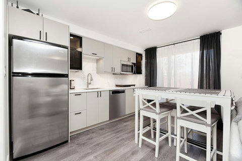 Kitchen equipped with 18 cft refrigerator,  double burner induction stove, quiet dishwasher,  vented microwave