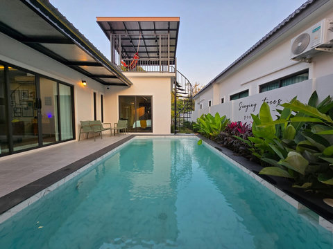 Outdoor seating area and balcony with hammock. 