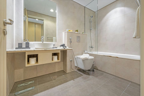 A sleekly designed bathroom, offering a comfortable and inviting space for your personal care with modern fixtures and stylish finishes.