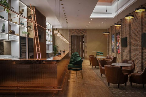 The building also features a chic bar, perfect for enjoying drinks and unwinding after a day of exploring the city.