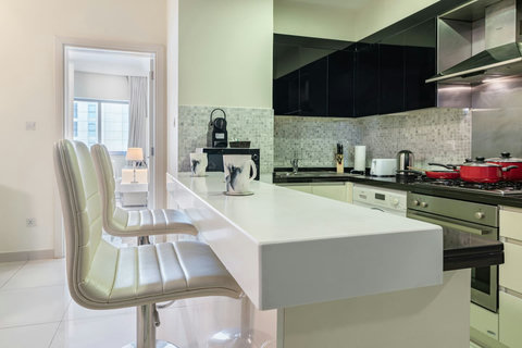 The kitchen is fully equipped with modern appliances and ample storage.