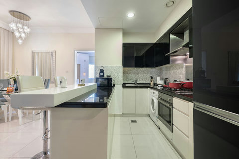 The kitchen is fully equipped with modern appliances and ample storage.