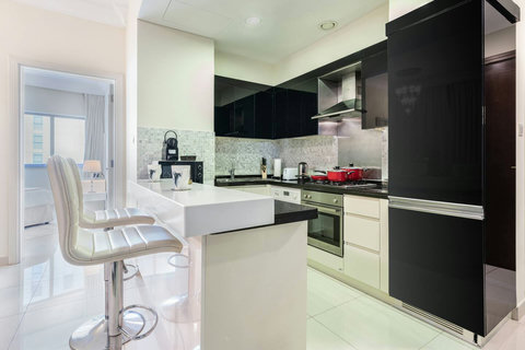 The kitchen is fully equipped with modern appliances and ample storage.