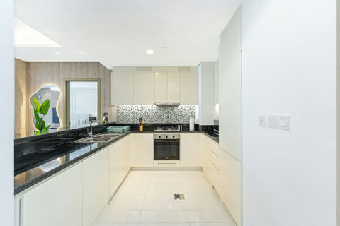 The kitchen is fully equipped with modern appliances and ample storage. It includes a large fridge, stove, oven, microwave, and a dishwasher making it ideal for your meal preps.