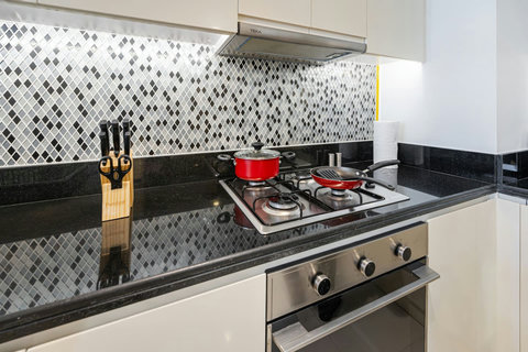 The kitchen is stocked with all the essential pots and pans, making it easy to prepare any meal.