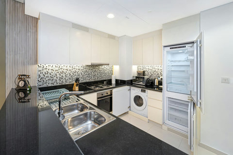 The kitchen is fully equipped with modern appliances and ample storage. It includes a large fridge, stove, oven, microwave, and a dishwasher making it ideal for your meal preps.