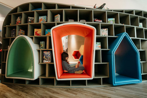 A cozy, kid-friendly space with fun house-shaped nooks, perfect for reading and great for families.