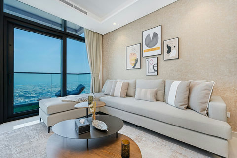 Relax on the cozy convertible sofa or step onto the balcony to enjoy amazing views of the city and waterfront through floor-to-ceiling windows.