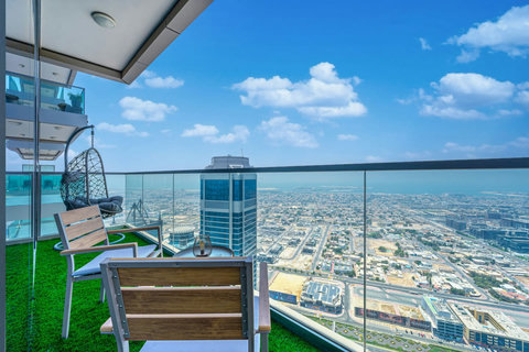 Enjoy a panoramic view of the bustling city, with towering skyscrapers and modern architecture, all set against an urban landscape from your balcony.