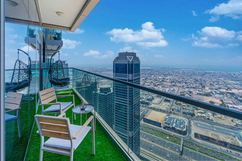 Enjoy a panoramic view of the bustling city, with towering skyscrapers and modern architecture, all set against an urban landscape from your balcony.