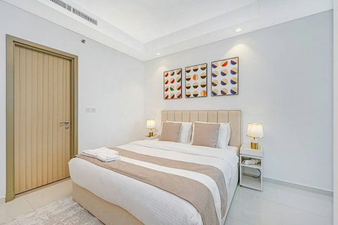 A cozy king bedroom with a stylish couch and plush bedding, all designed for your comfort. You’ll love the decorative pillows and luxurious finishes!