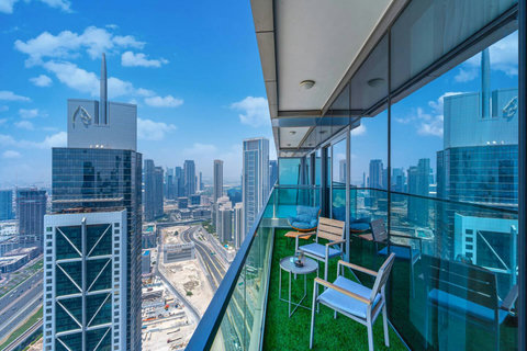 Enjoy a panoramic view of the bustling city, with towering skyscrapers and modern architecture, all set against an urban landscape from your balcony.