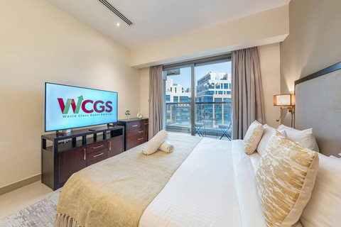 Wake up in a bright room with a plush king bed, modern lighting, and views of Downtown Dubai—perfect for an amazing stay!