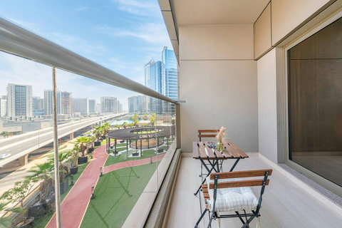 Enjoy a cozy balcony sitting area for two with uninterrupted views of Dubai's bustling city.