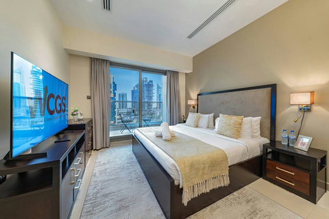 Wake up in a bright room with a plush king bed, modern lighting, and views of Downtown Dubai—perfect for an amazing stay!