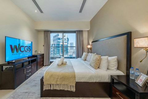 Wake up in a bright room with a plush king bed, modern lighting, and views of Downtown Dubai—perfect for an amazing stay!