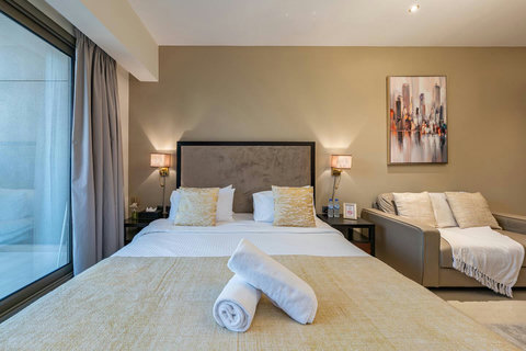 Wake up in a bright room with a plush king bed, modern lighting, and views of Downtown Dubai—perfect for an amazing stay!
