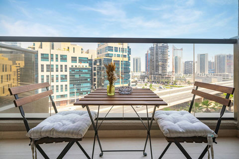 Enjoy a cozy balcony sitting area for two with uninterrupted views of Dubai's bustling city.