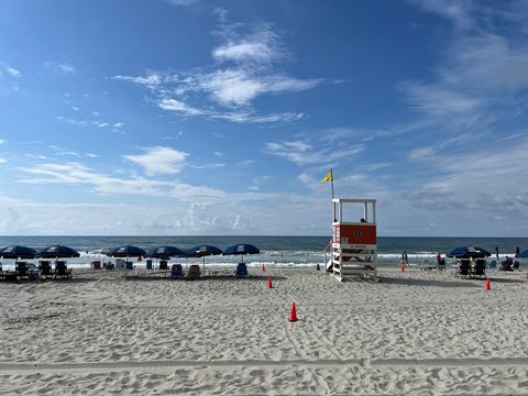 Beachfront Retreat: Enjoy stunning ocean views and lounge under colorful umbrellas just steps away!