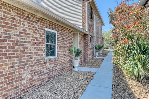 Exterior Charm: Relax amidst vibrant landscaping and brick accents in sunny North Myrtle Beach!