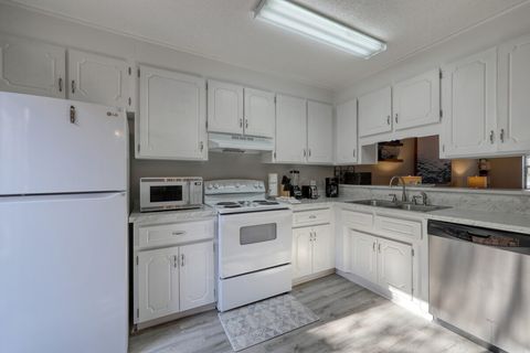 Kitchen: Bright white cabinetry and modern appliances make cooking a delight in this beach retreat!